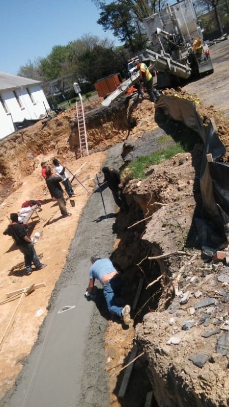 A group of construction workers are working on a road