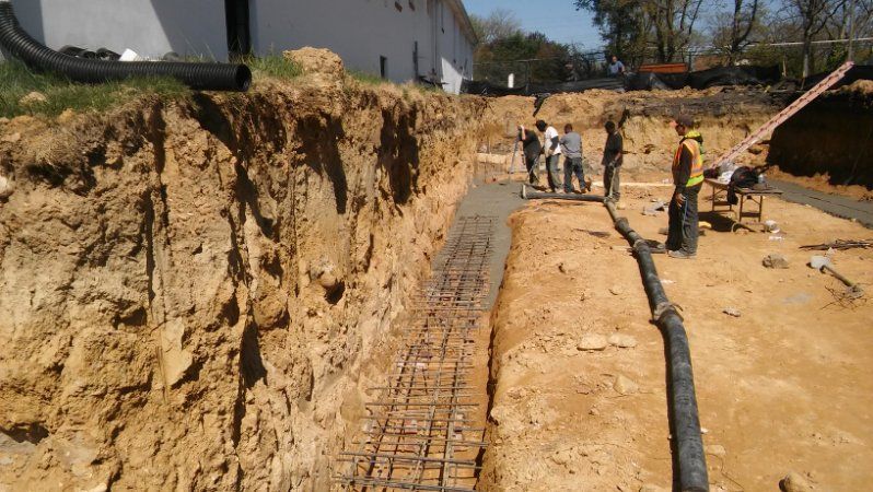 A group of construction workers are working on a construction site.