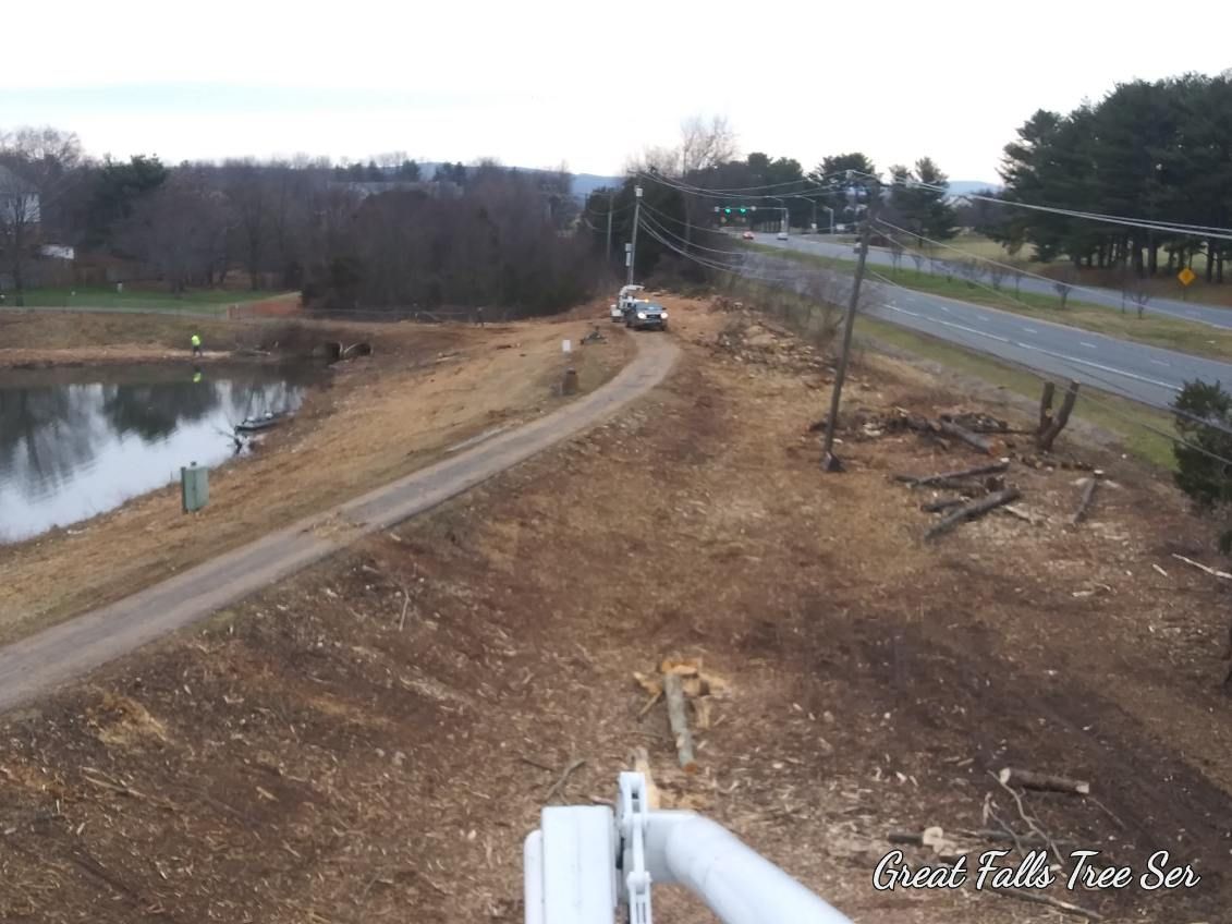 An aerial view of a dirt road leading to a lake