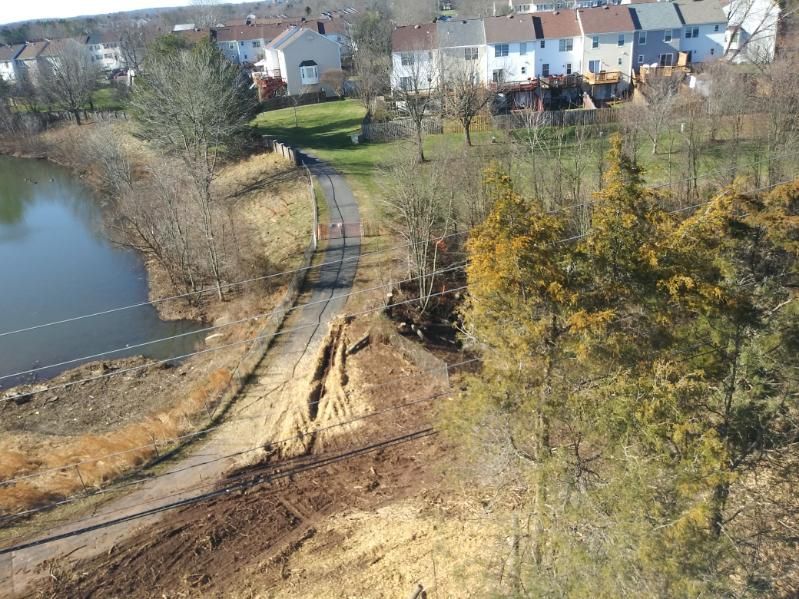 An aerial view of a residential area with a lake in the background