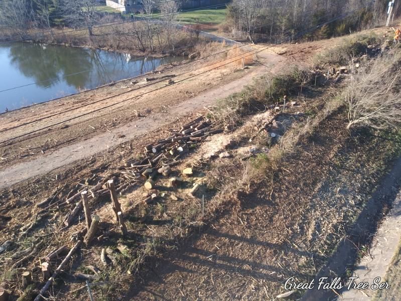 An aerial view of a dirt road next to a lake