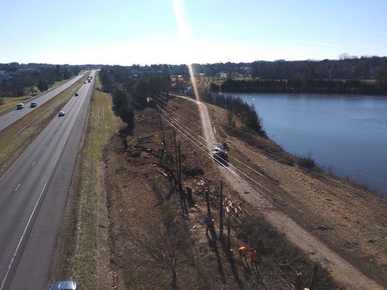 An aerial view of a highway next to a body of water.