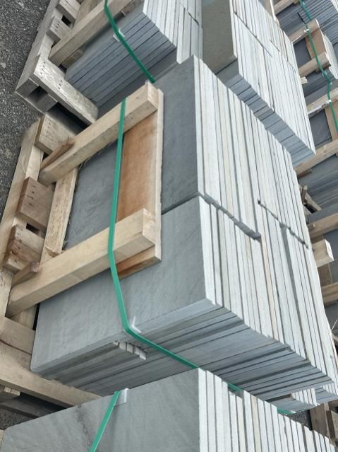 A wooden pallet with stacks of tiles on it