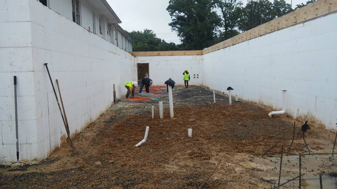 A group of construction workers are working on a construction site.