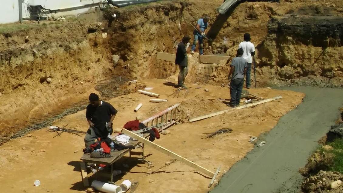 A group of people are working on a construction site.