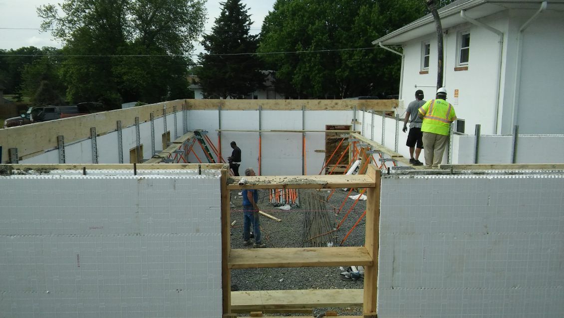 A group of construction workers are working on a building under construction.