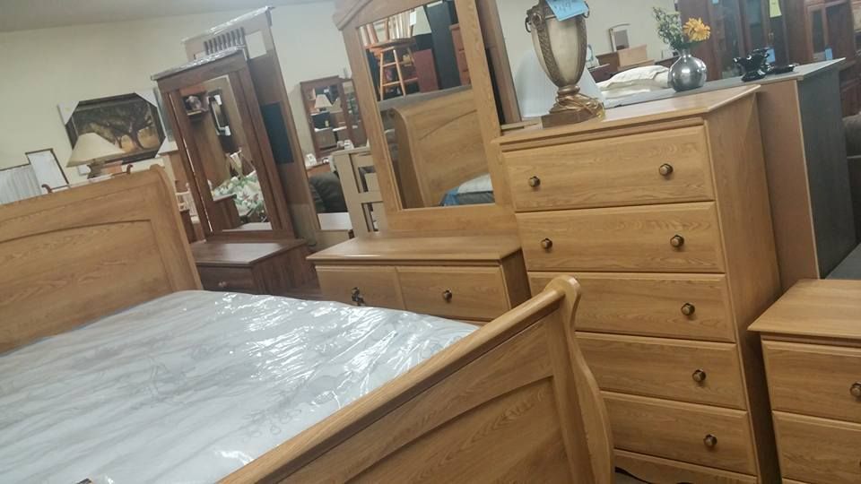 Bedroom furniture set in light wood: bed, dresser, mirror, nightstand.