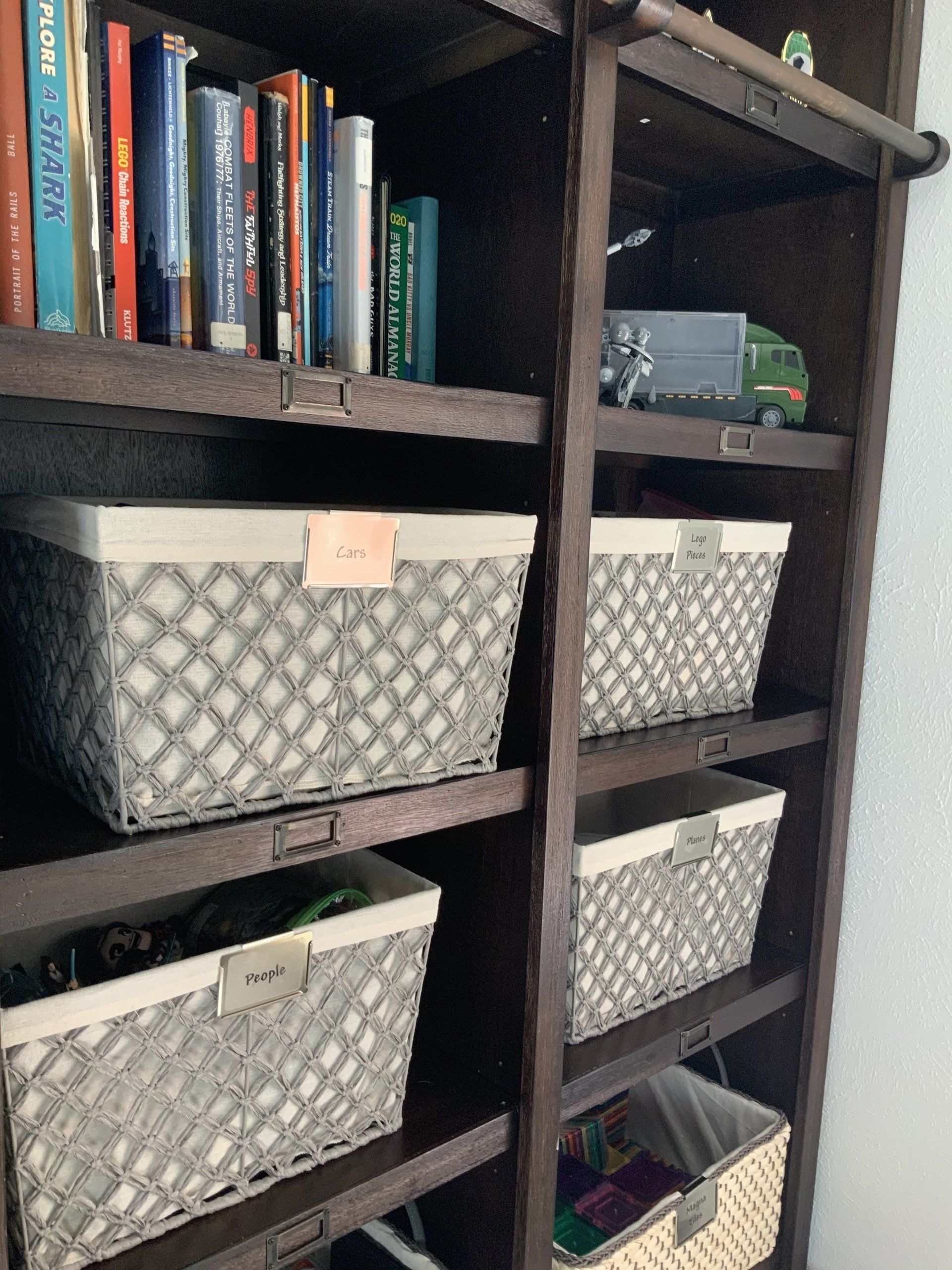 Large pantry wall organized with sea grass bins, white containers with handles, Mackenzie child’s accents, back stock and glass jars. How to oragize your pantry, how to organize your baking products, how to organize a boys room, how to organize toys, how to fold clothes, how to organize boys toys, pantry with plastic bins, storage furniture, how to organize a desk