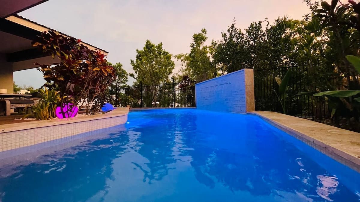 Swimming Pool With Blue Water, Illuminated at Dusk, Adjacent to a Wall — Rod Hardy Plunge Pools in Girraween, NT