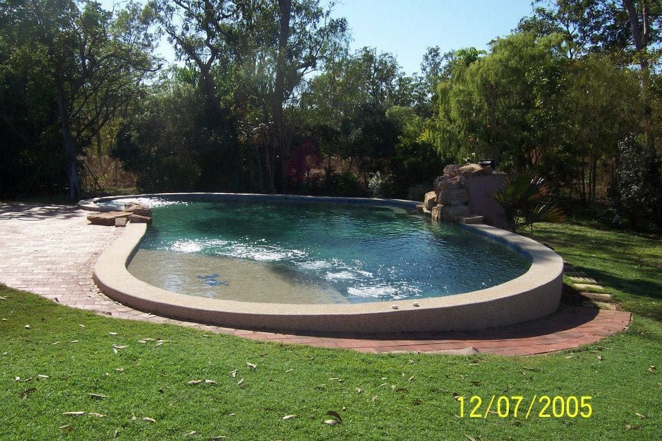A Kidney-shaped Swimming Pool in a Grassy Yard, Surrounded by Tree — Rod Hardy Plunge Pools in Girraween, NT