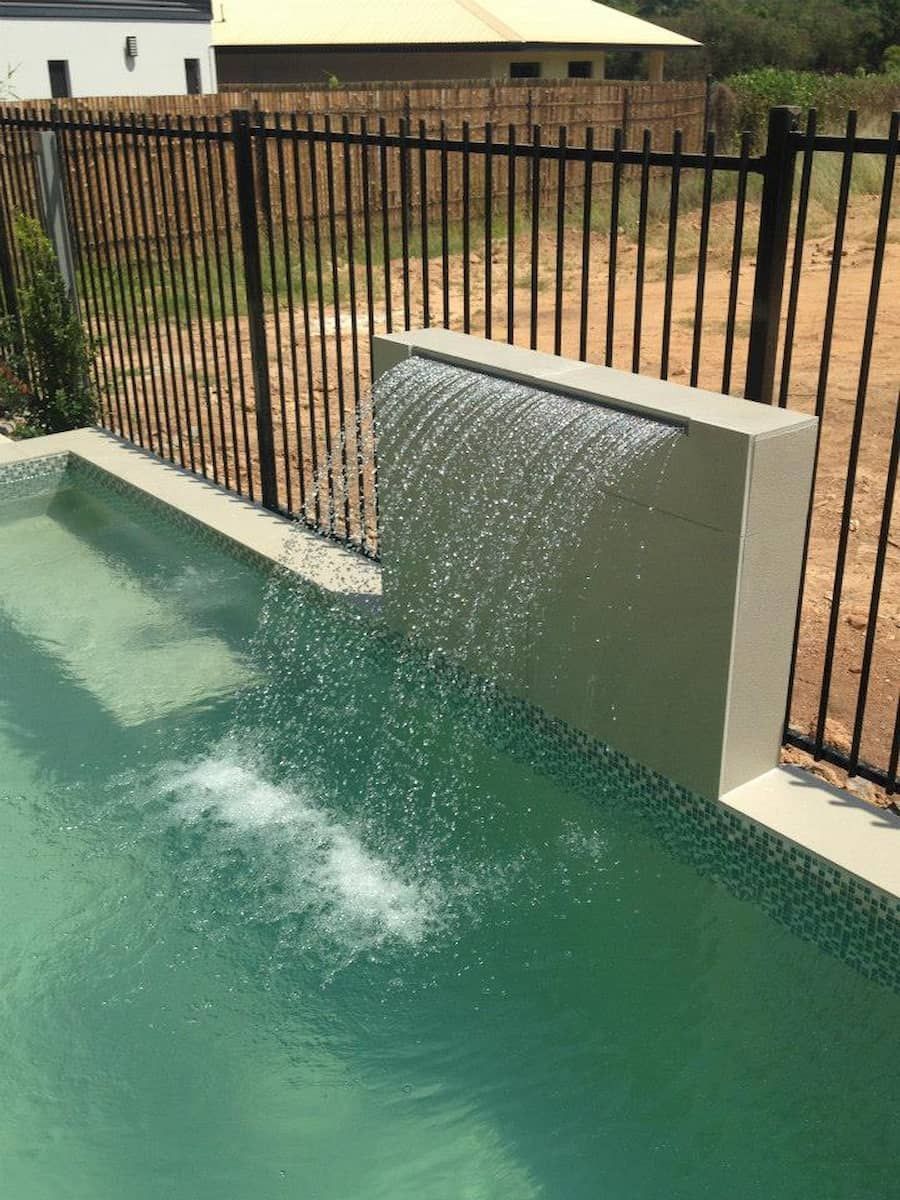 Pool With Waterfall Feature and Black Fence — Rod Hardy Plunge Pools in Palmerston, NT