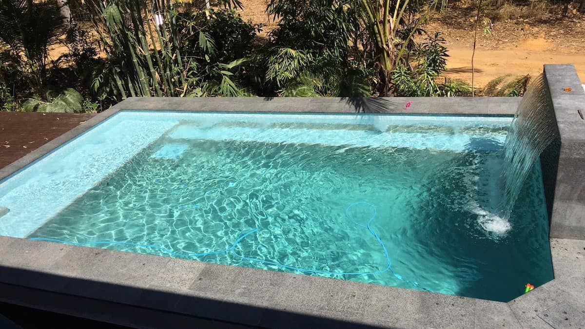 Small Rectangular Pool With Clear Blue Water and a Waterfall Feature — Rod Hardy Plunge Pools in Palmerston, NT