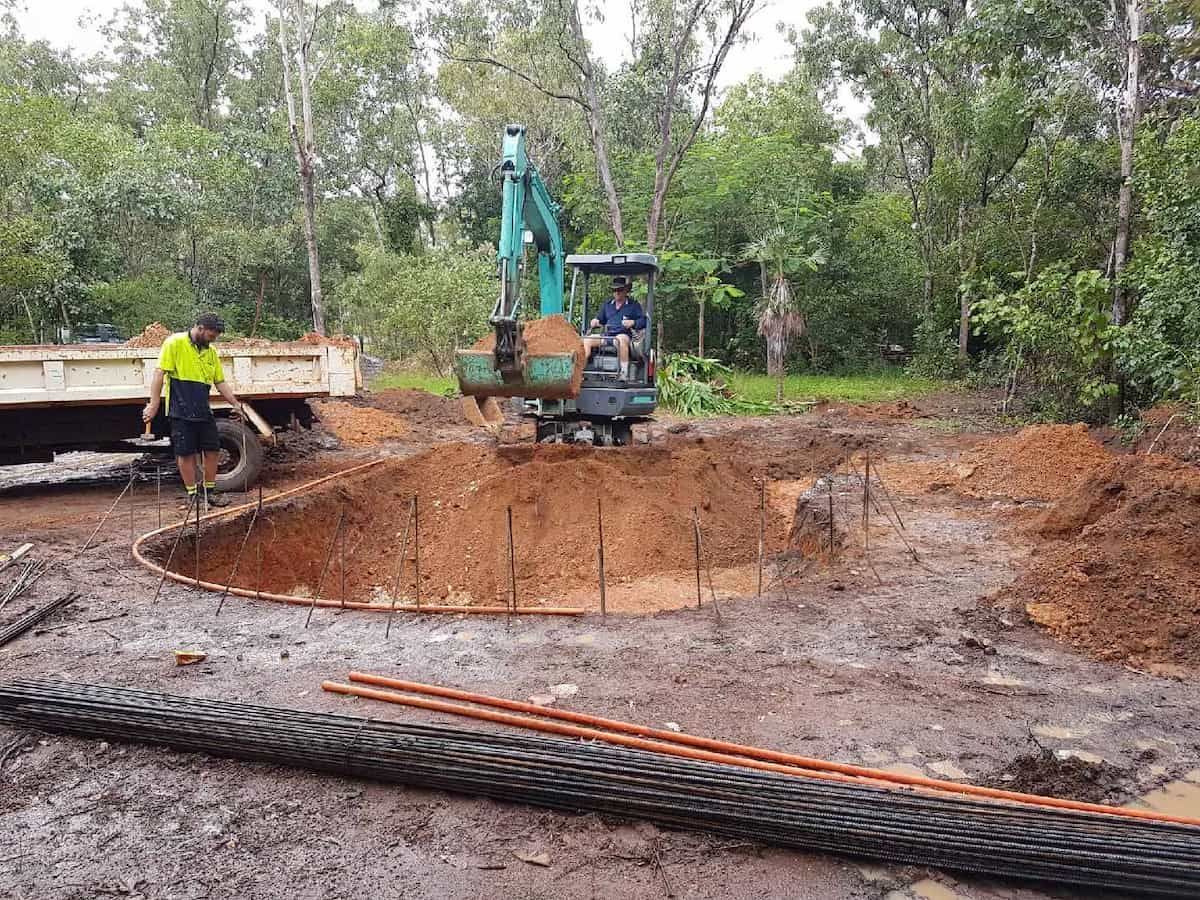 Excavator Digging in Muddy Dirt, a Truck and Worker Present — Rod Hardy Plunge Pools in Girraween, NT