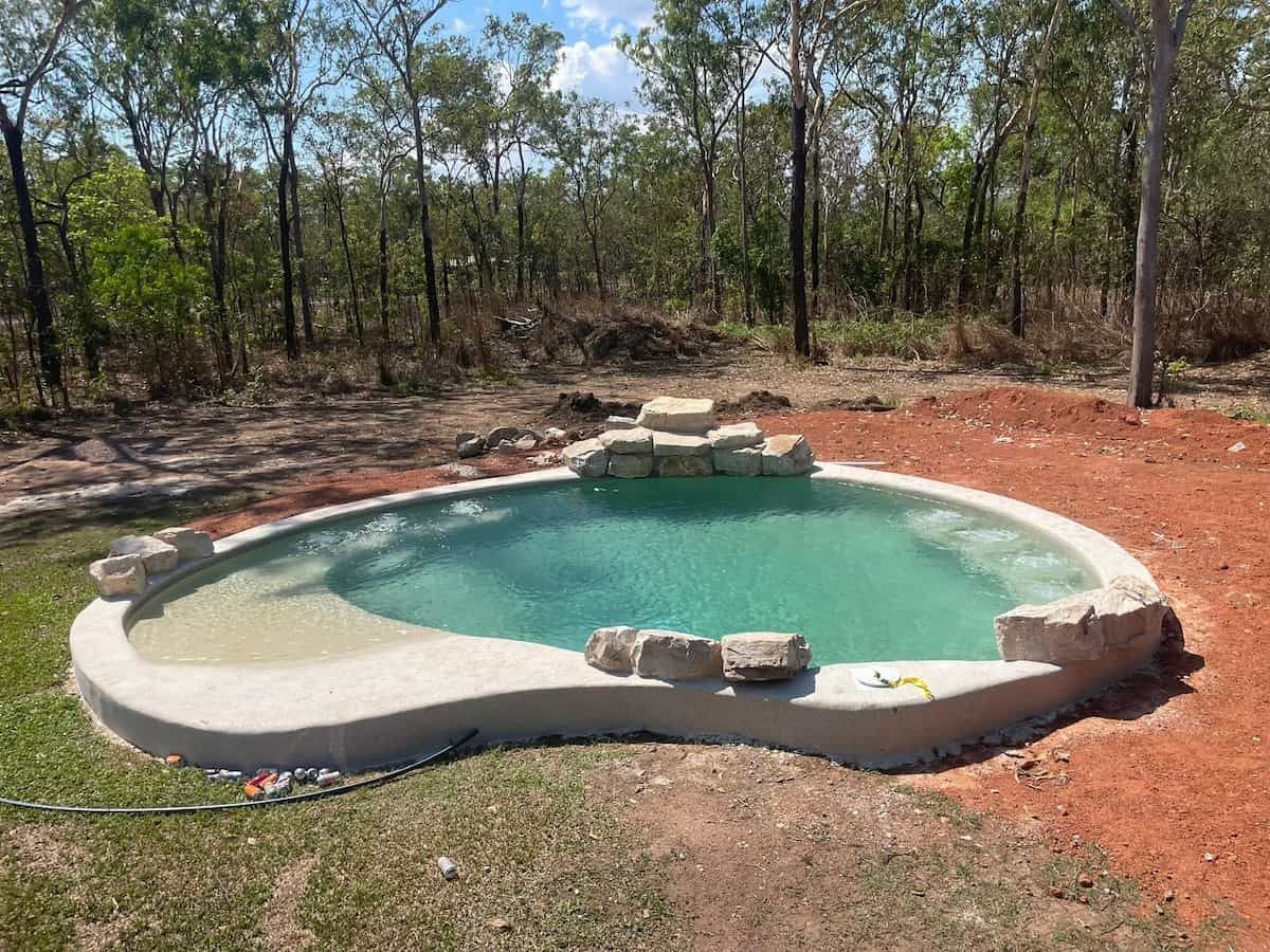 Oval-shaped Swimming Pool With Light Blue Water and Stone Accents — Rod Hardy Plunge Pools in Palmerston, NT