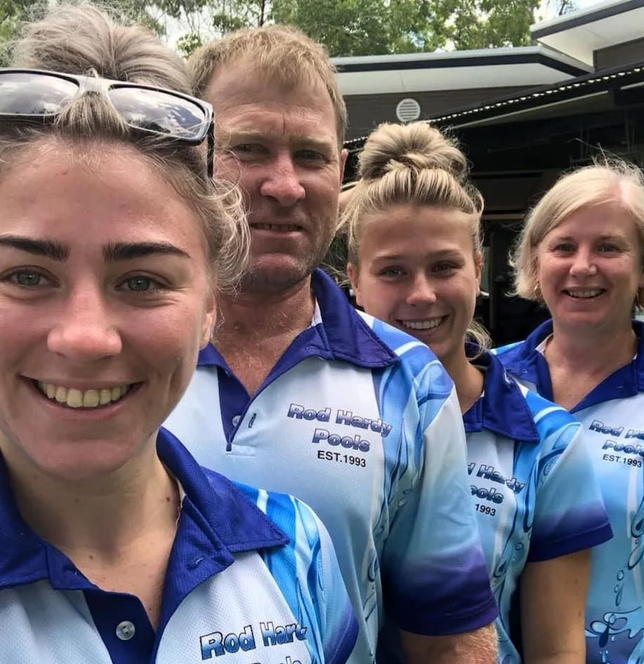 Four People Smiling, Wearing Matching Blue Shirts — Rod Hardy Plunge Pools in Girraween, NT