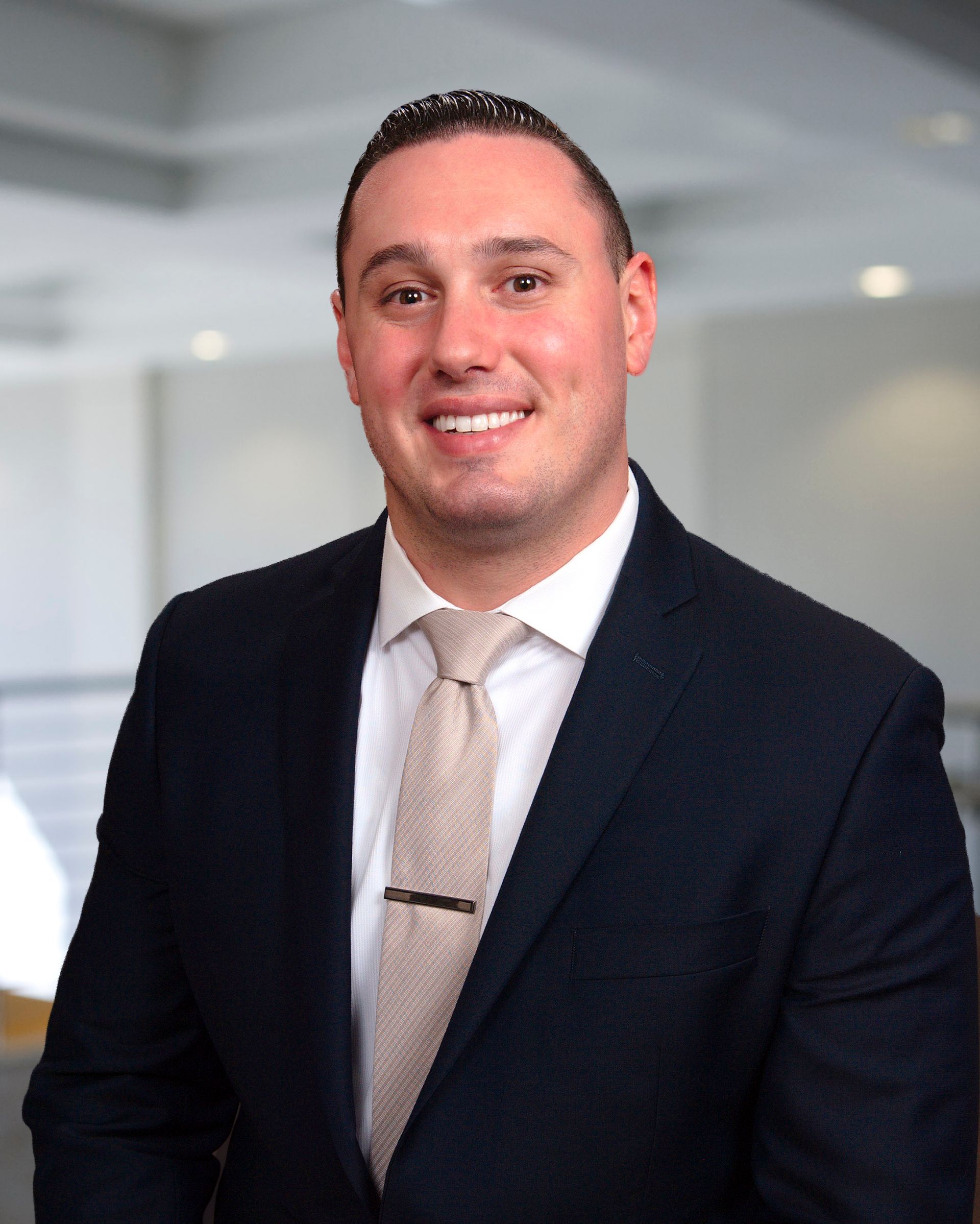 A man in a suit and tie is smiling for the camera.