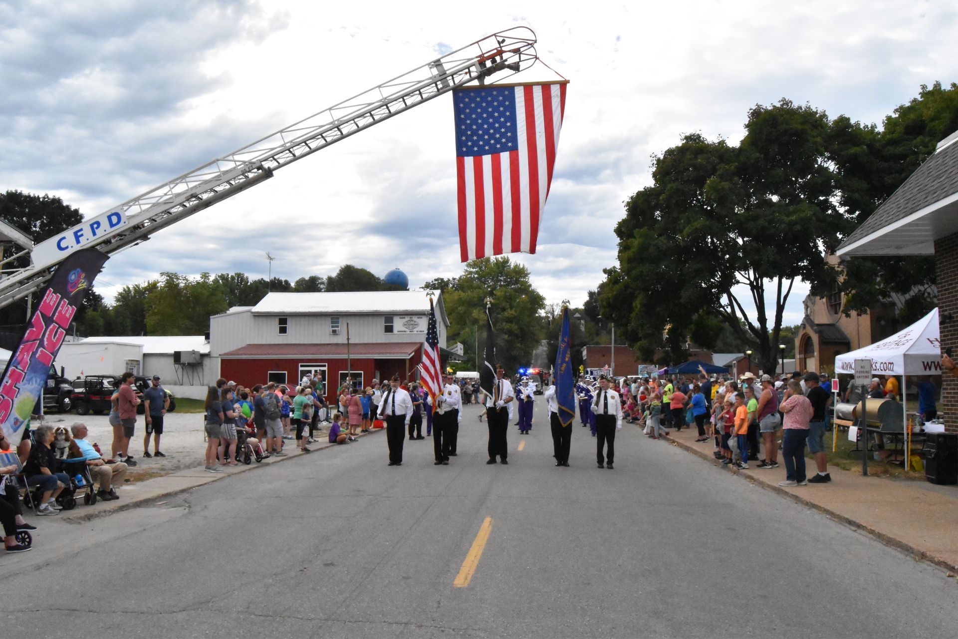A group of people are marching down a street in a parade.