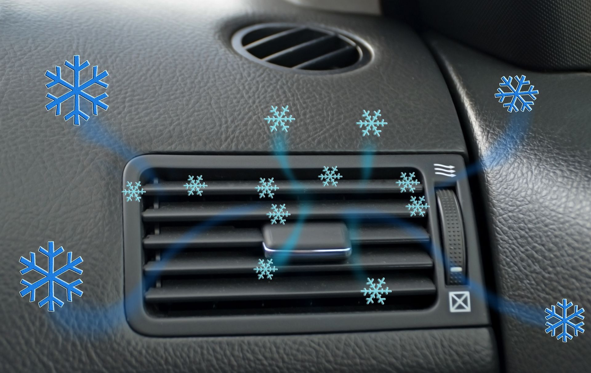A car air vent with snowflakes coming out of it