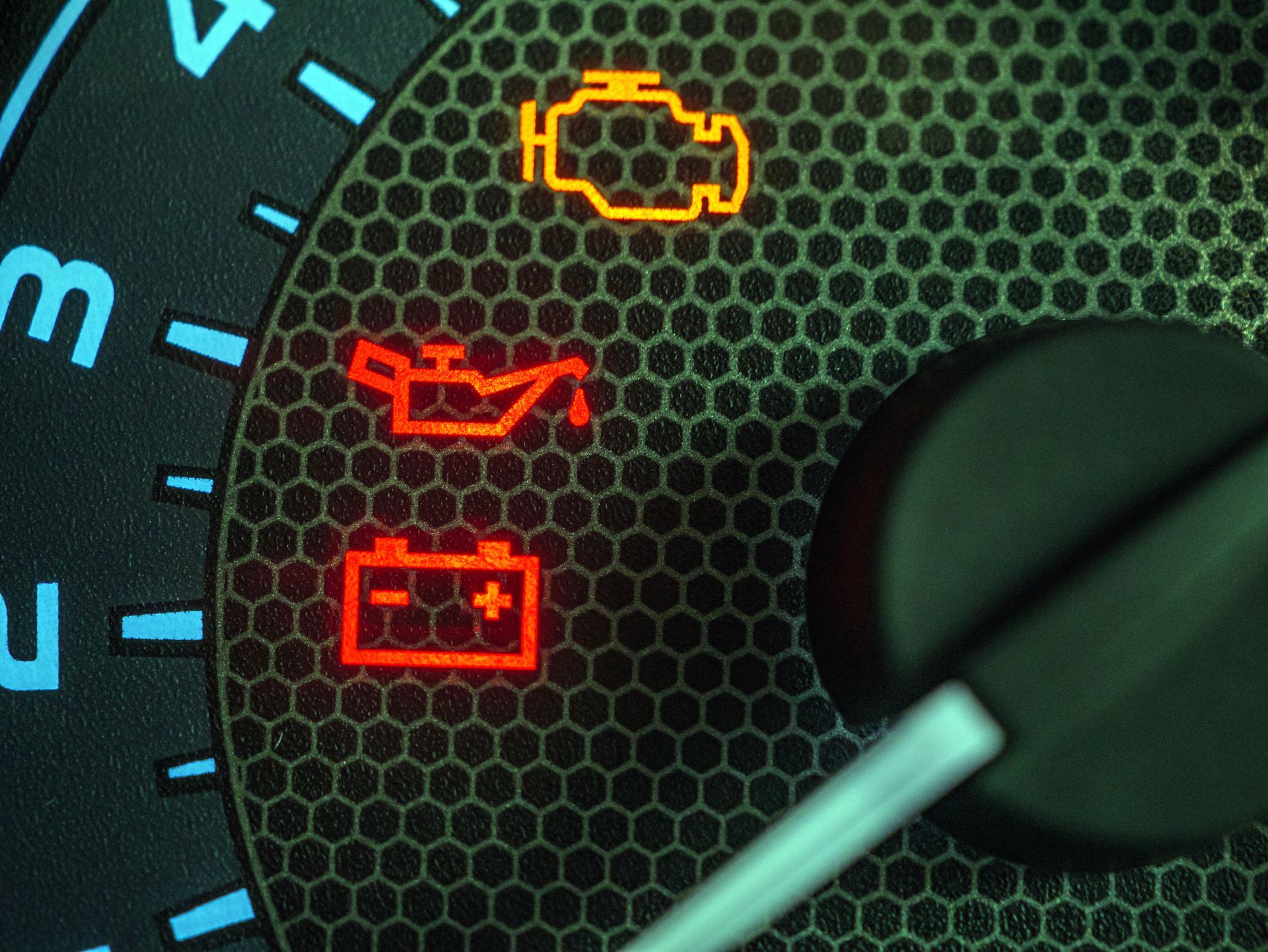 A close up of a car dashboard with various lights on