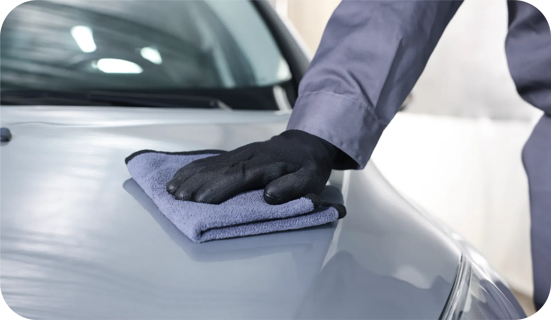 Black McLaren sports car parked on a street, license plate 
