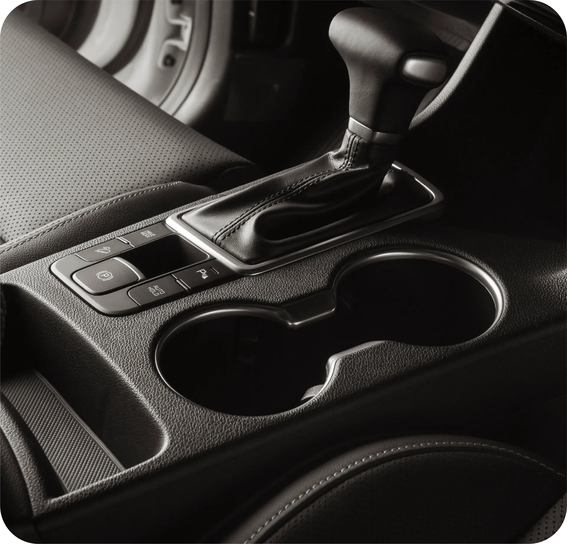 Tan leather interior of a luxury car with a touchscreen display and a black steering wheel.