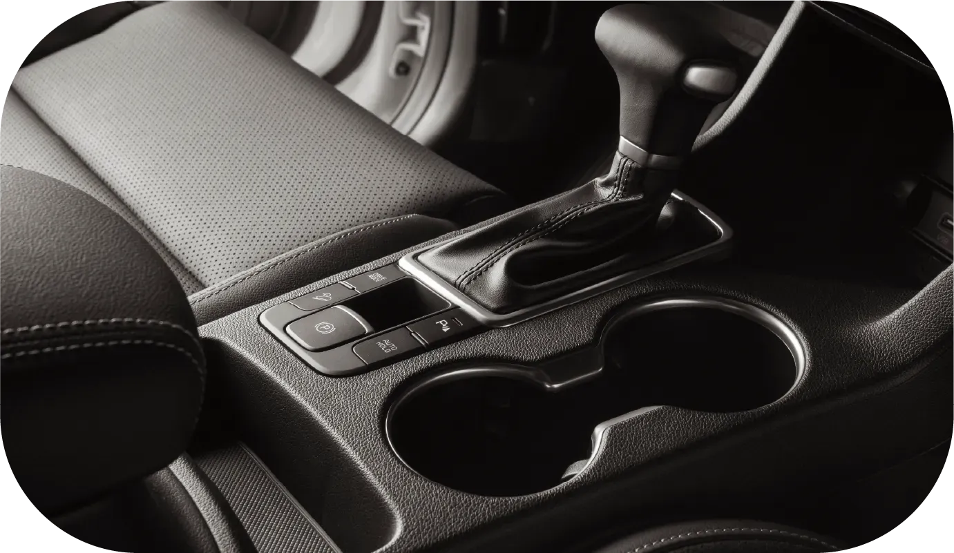 Close-up of a teal-colored car hood with water droplets on the surface.