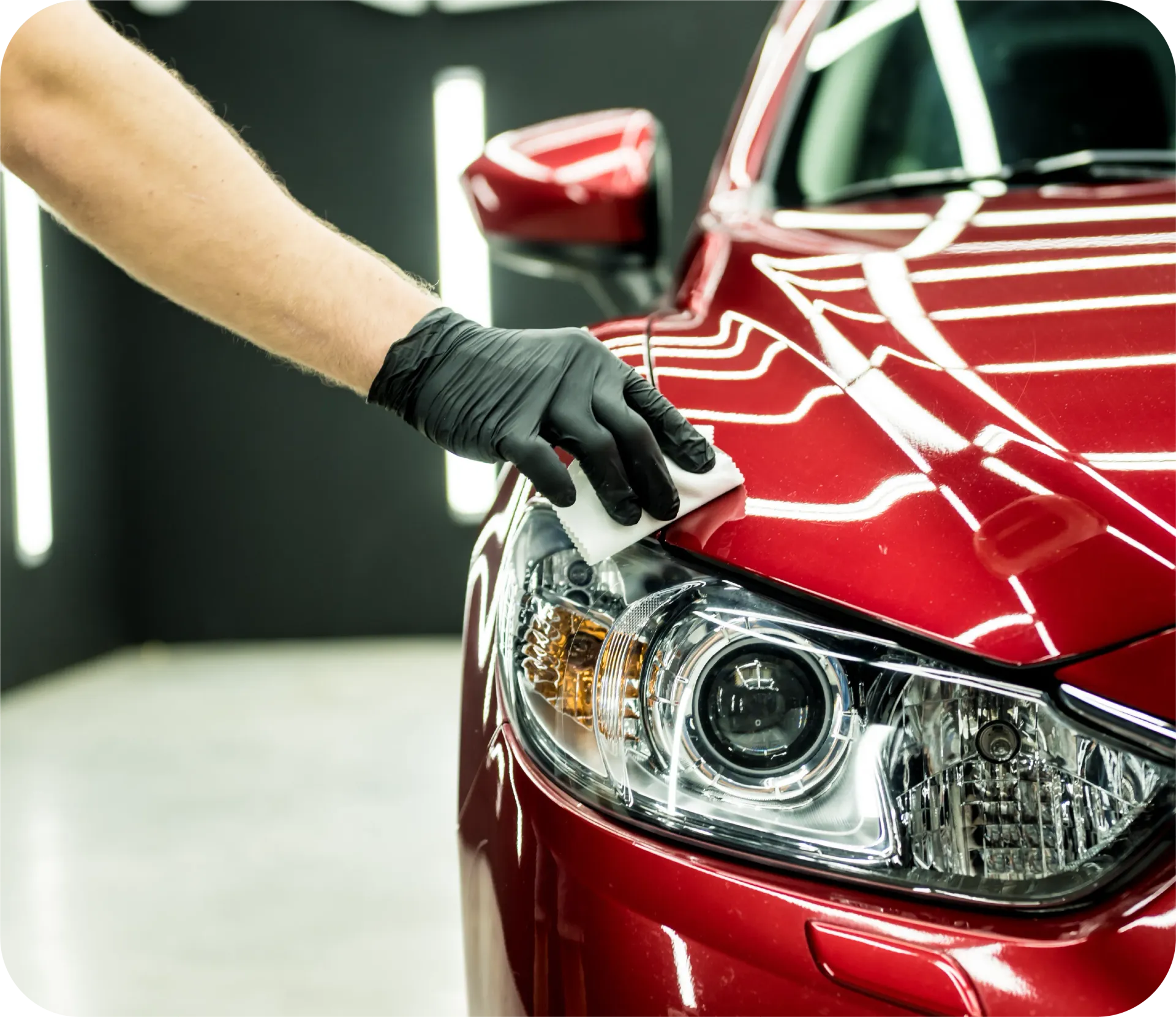 Water droplets on a dark maroon surface.