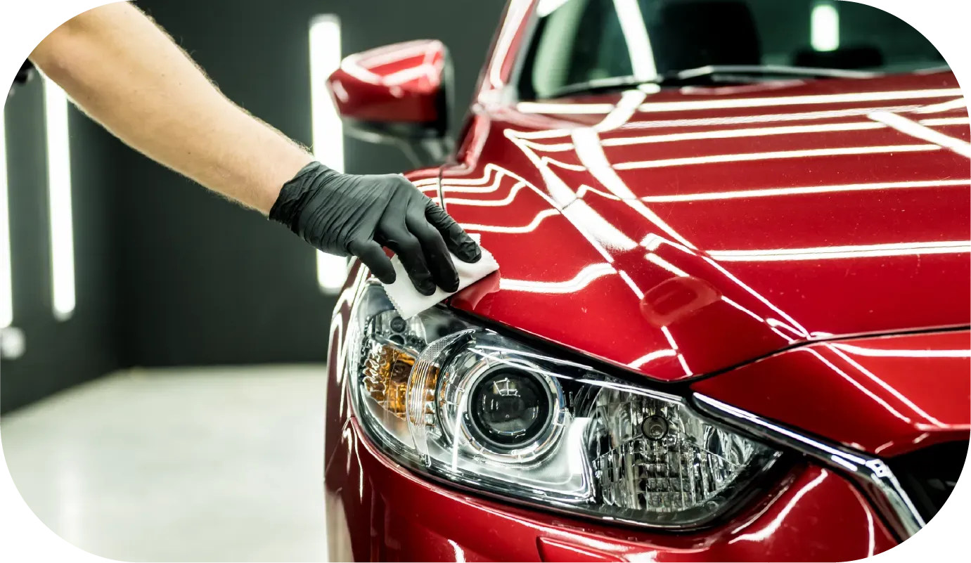 Water droplets on a dark red surface, creating a textured pattern.