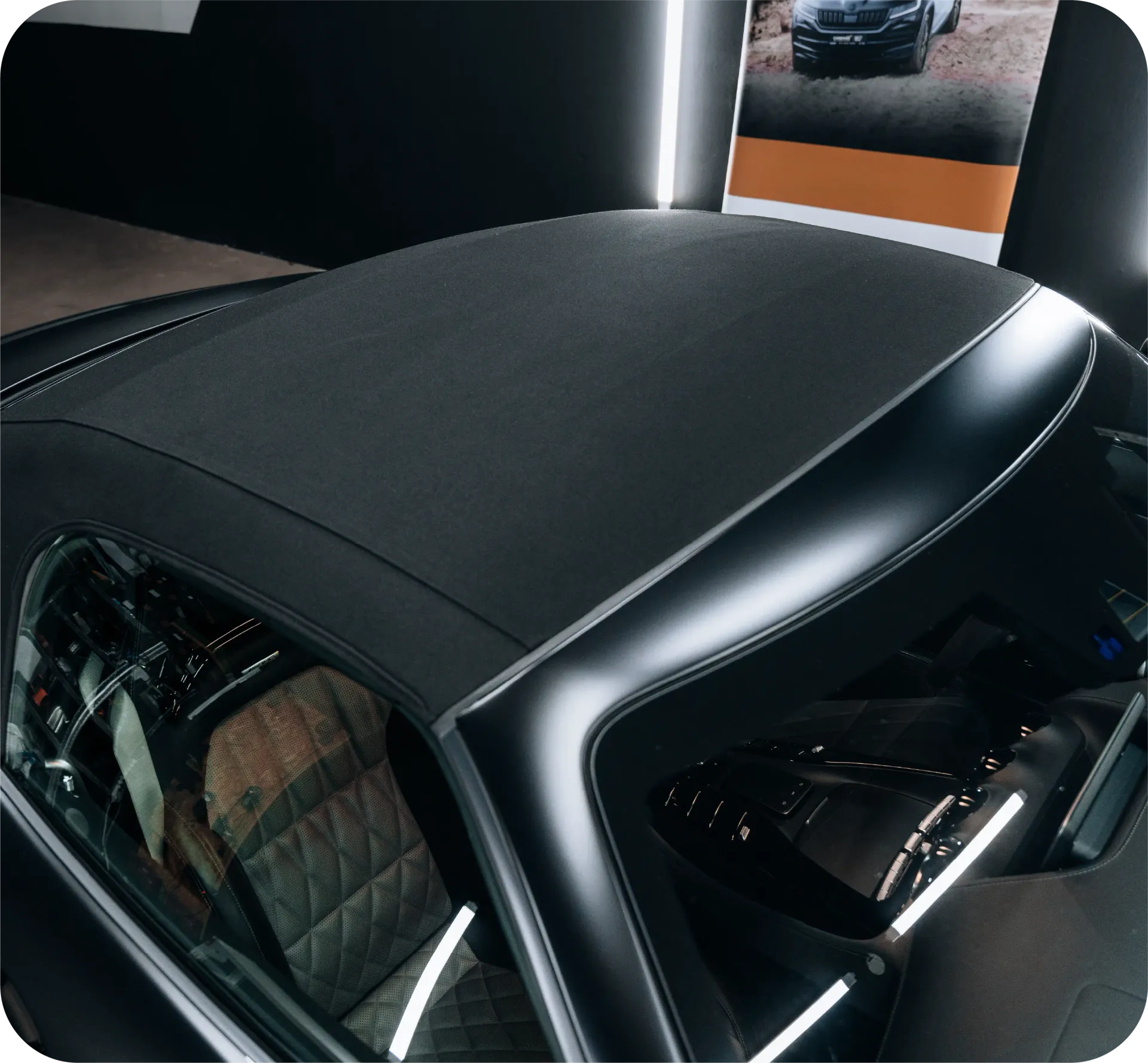 Classic blue Mercedes convertible parked in front of a white van labeled 