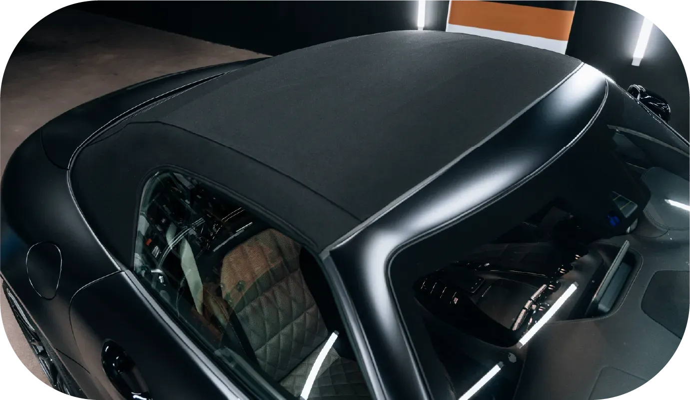 Blue classic Mercedes convertible on a gravel driveway. Two-tone paint, blue soft top, chrome details.