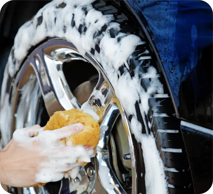 Blue Ferrari car door with emblem, covered in soap.