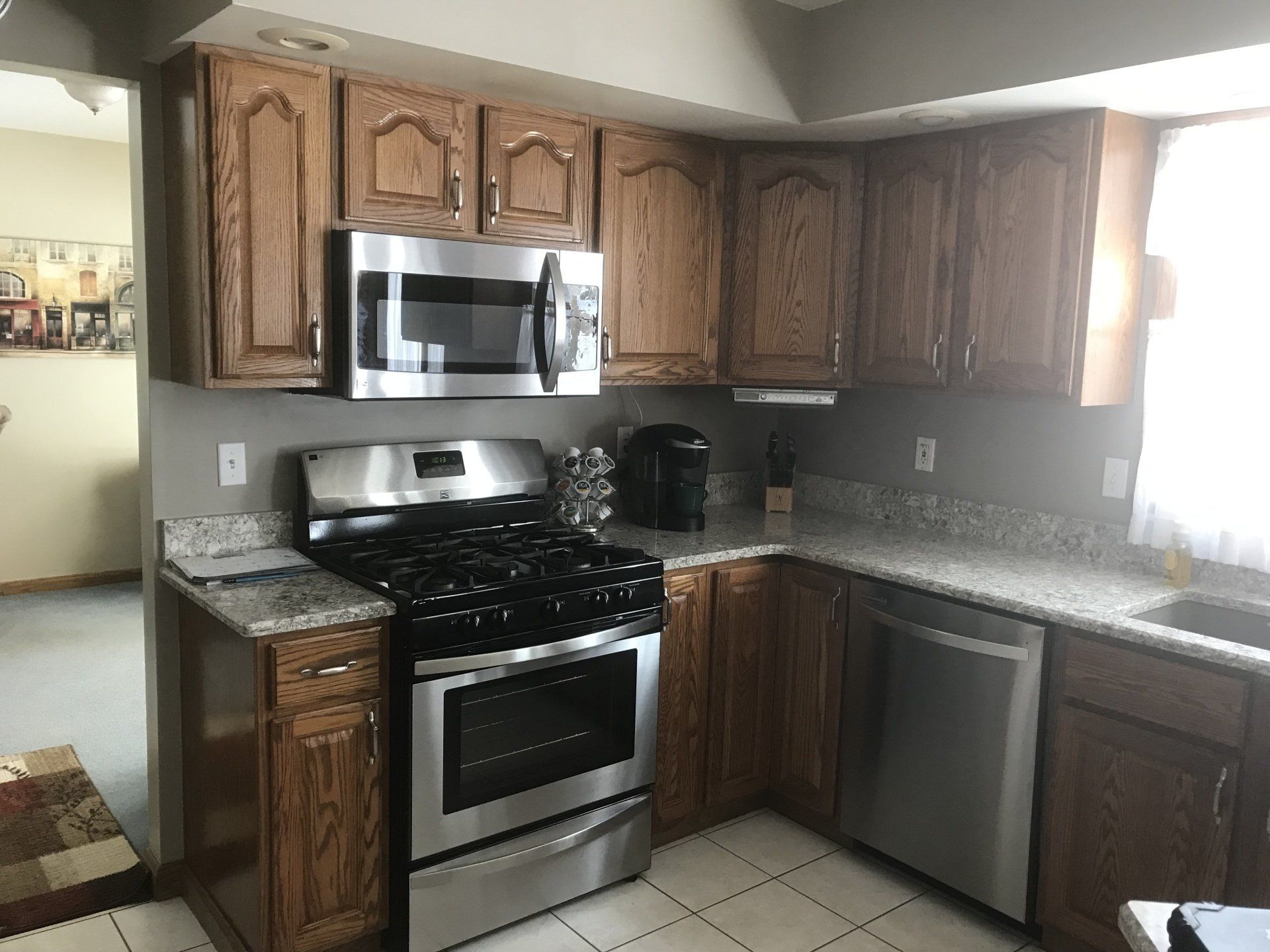 A kitchen with stainless steel appliances and wooden cabinets