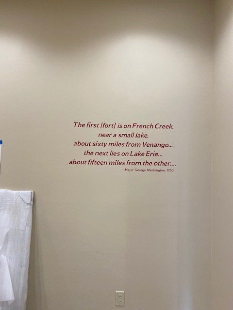A bathroom wall with a quote on it.