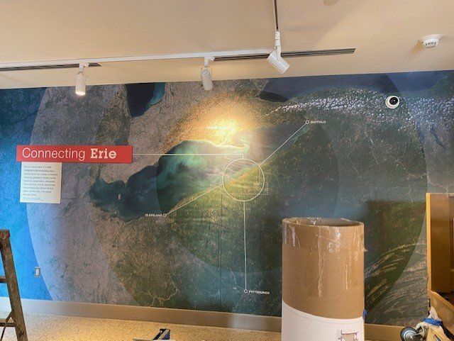 A wall with a map on it that says connecting erie