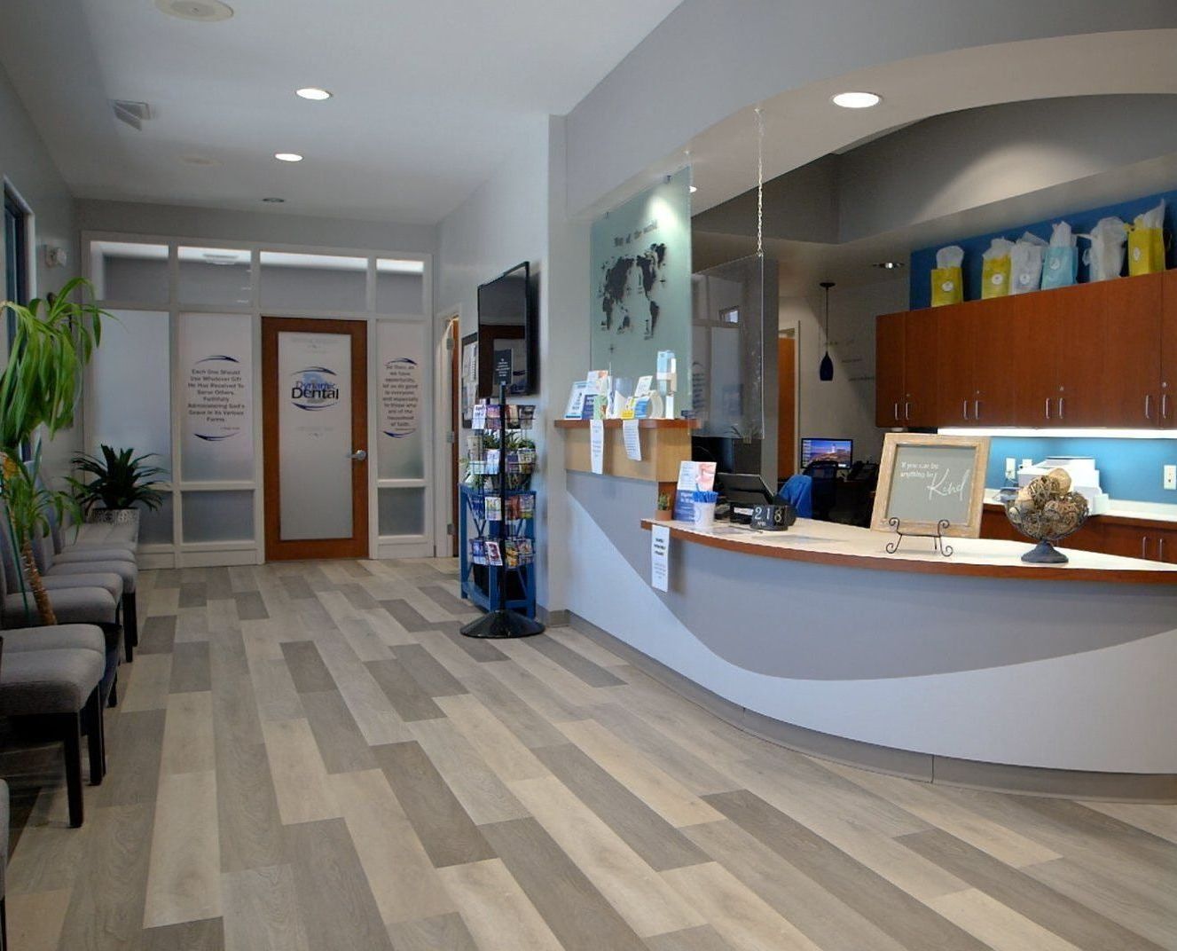 A waiting room with a counter and chairs in a hospital.