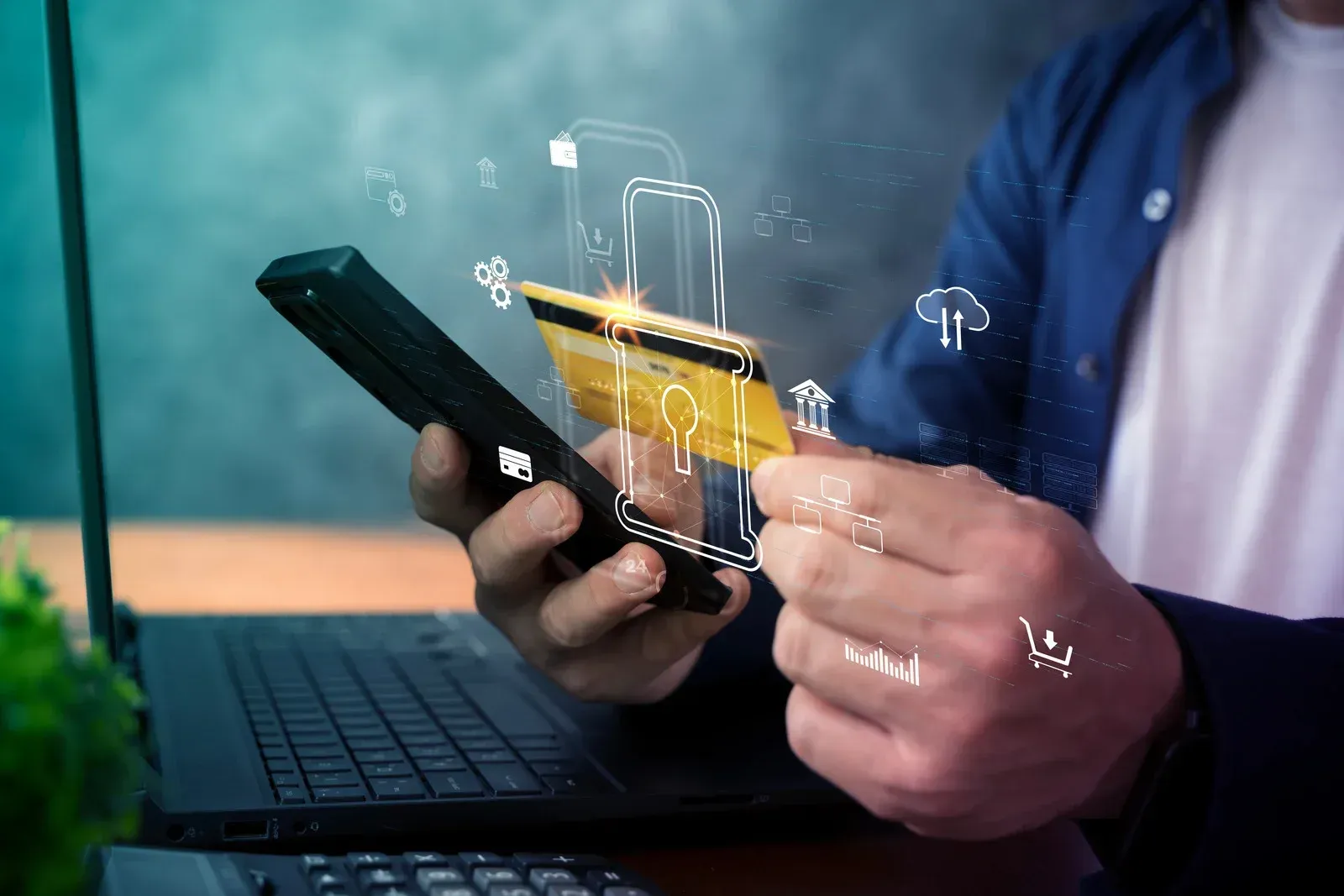 Hand using a smartphone with a transparent security overlay and floating digital icons beside a laptop