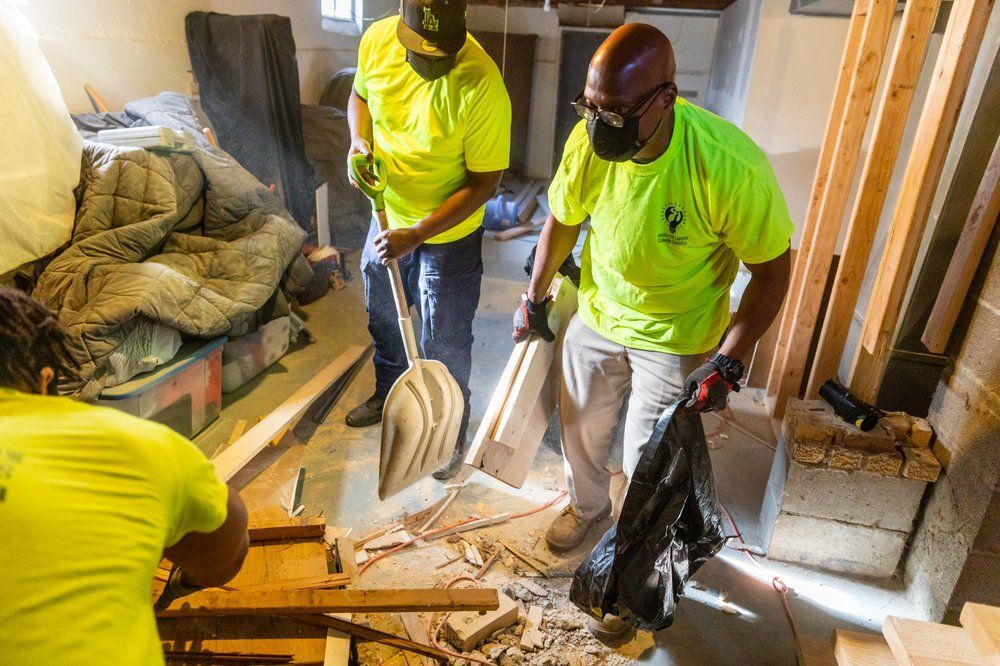 a group of construction workers are working in a room .