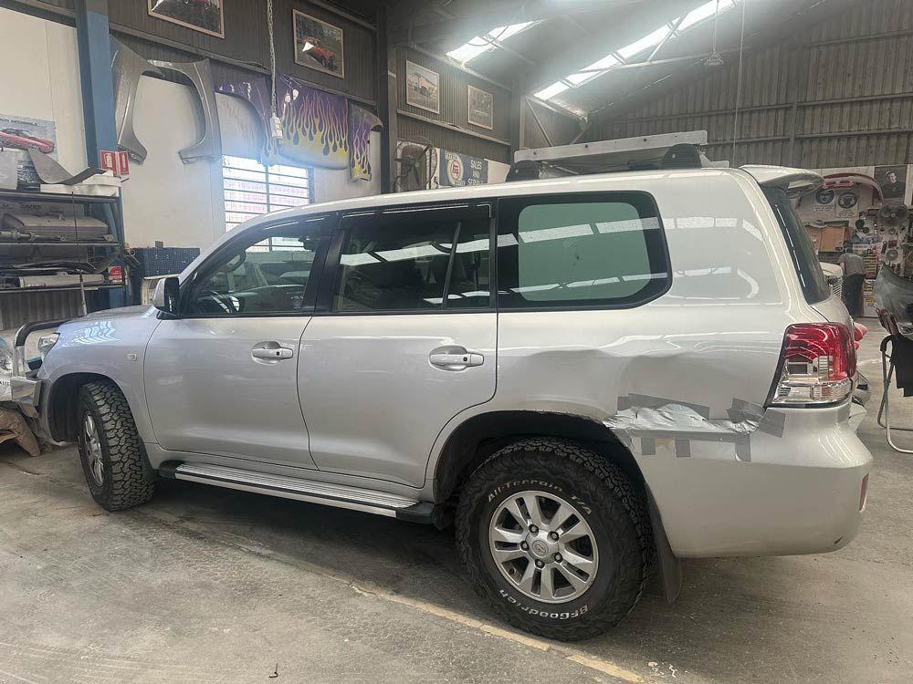 White Vehicle Damaged — John Zelukovic Smash Repairs in Orange, NSW
