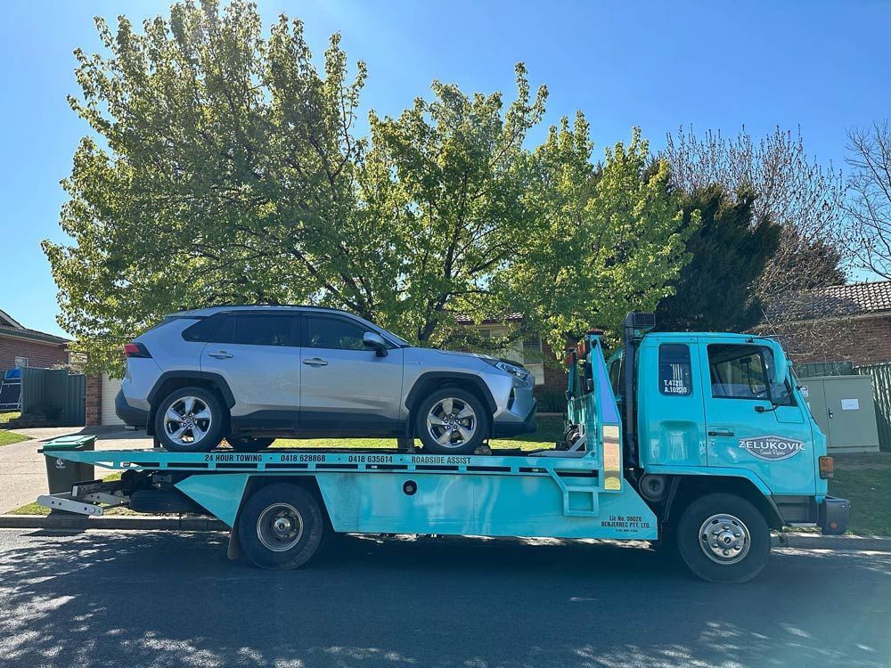 Towed Car on Company Truck — John Zelukovic Smash Repairs in Orange, NSW
