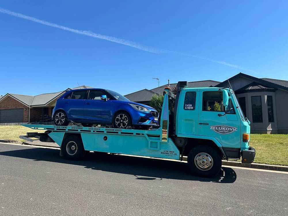 Blue SUV Towing Service — John Zelukovic Smash Repairs in Orange, NSW
