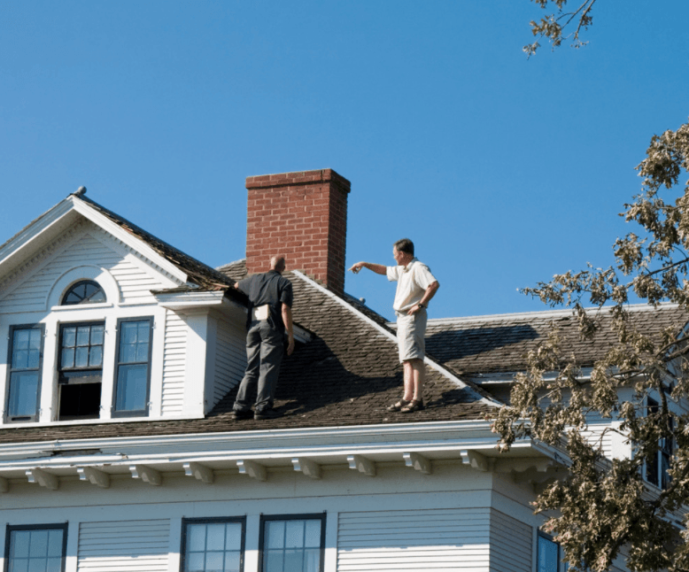 Roofing contractor meeting insurance adjuster