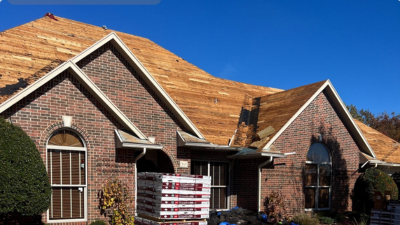 Roofing contractor installing new roof