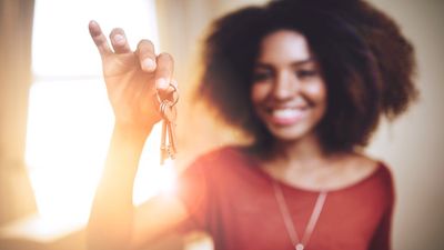woman holding up a key