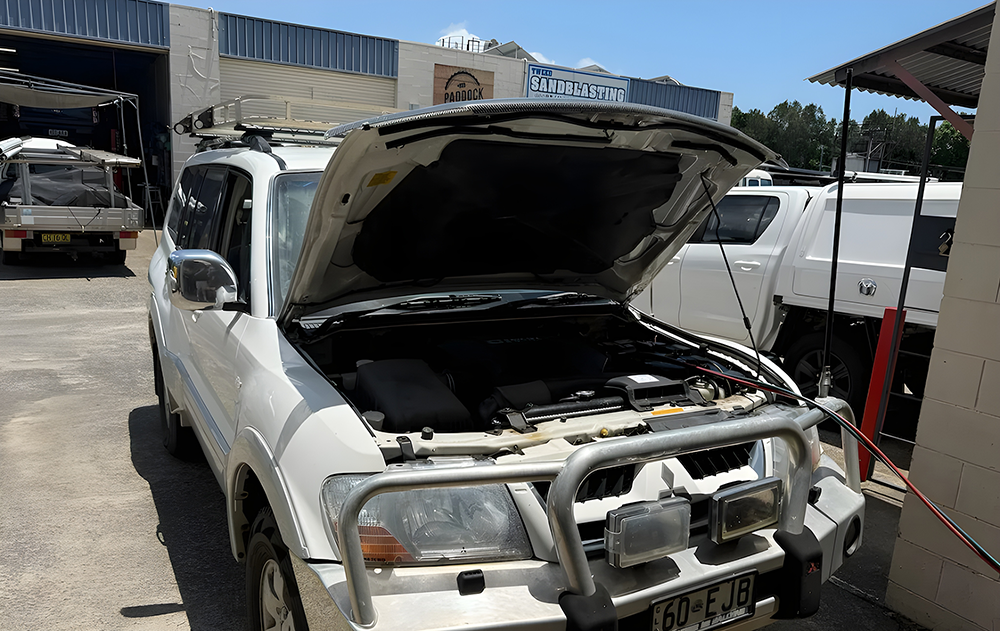 White SUV Open Hood Workshop