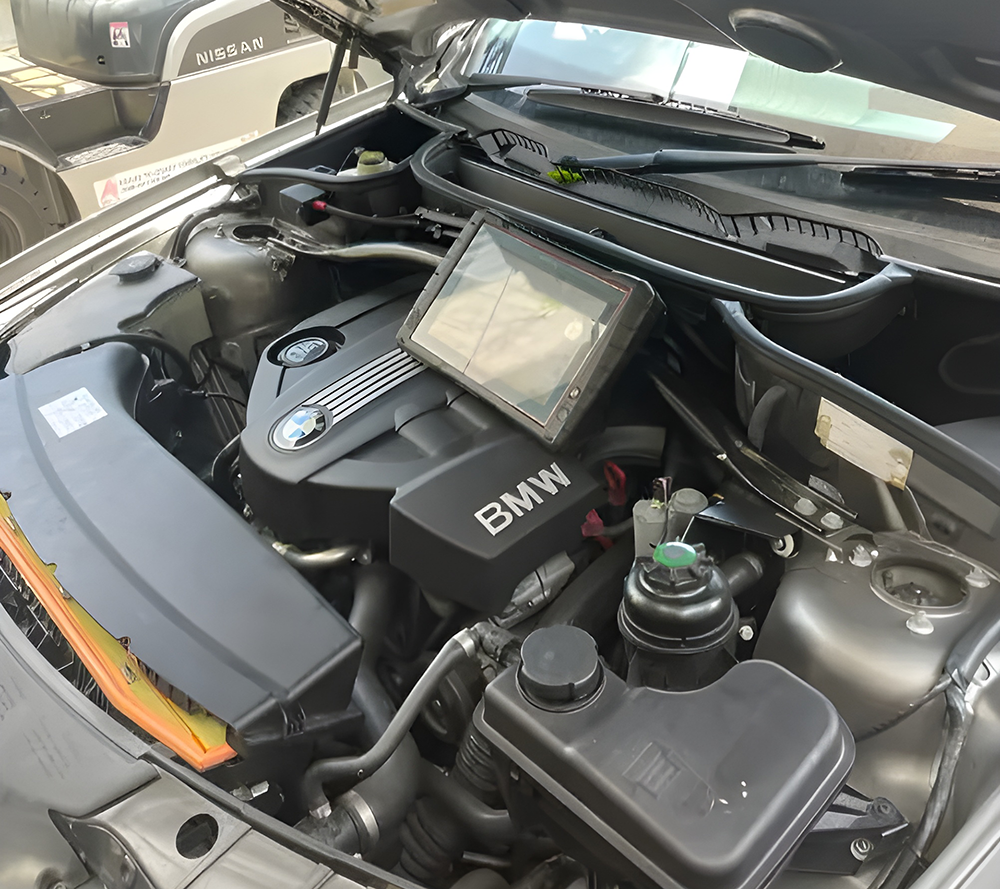 Car Engine Bay with a Diagnostic Tablet