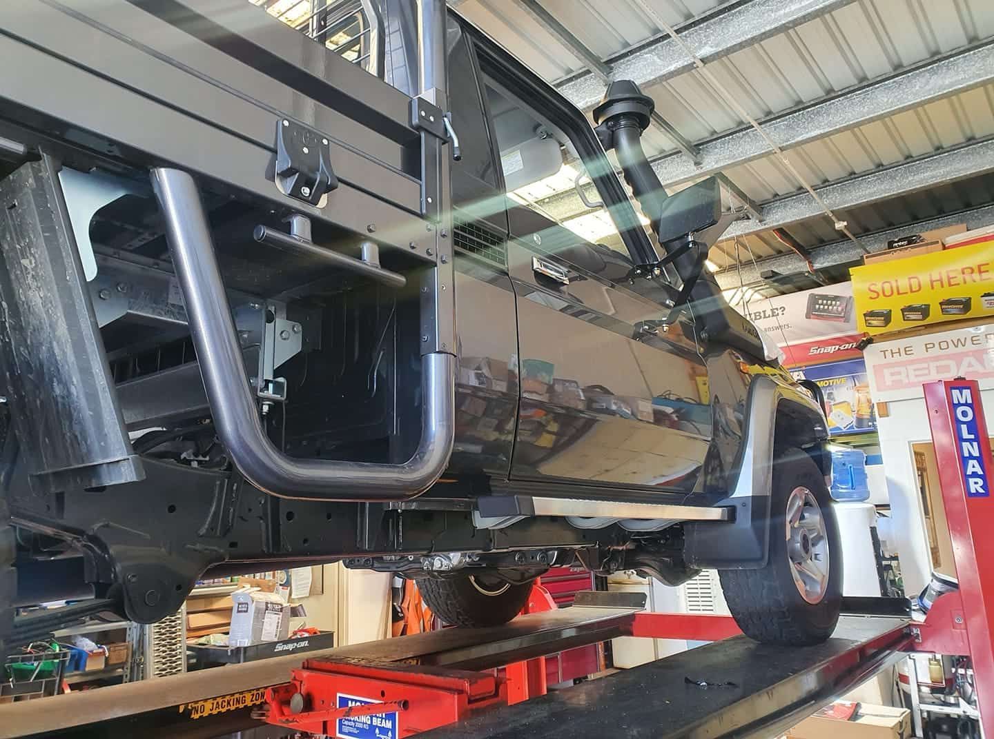 A Truck Is Sitting On Top Of A Lift In A Garage — Cabba Auto Electrics In Chinderah, NSW