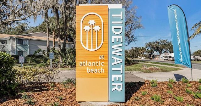 Sign for Tidewater at Atlantic Beach apartments with palm tree logo.