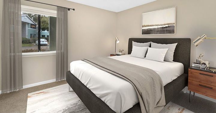 Bedroom with a bed, nightstand, window with curtains, and artwork. Neutral color scheme.