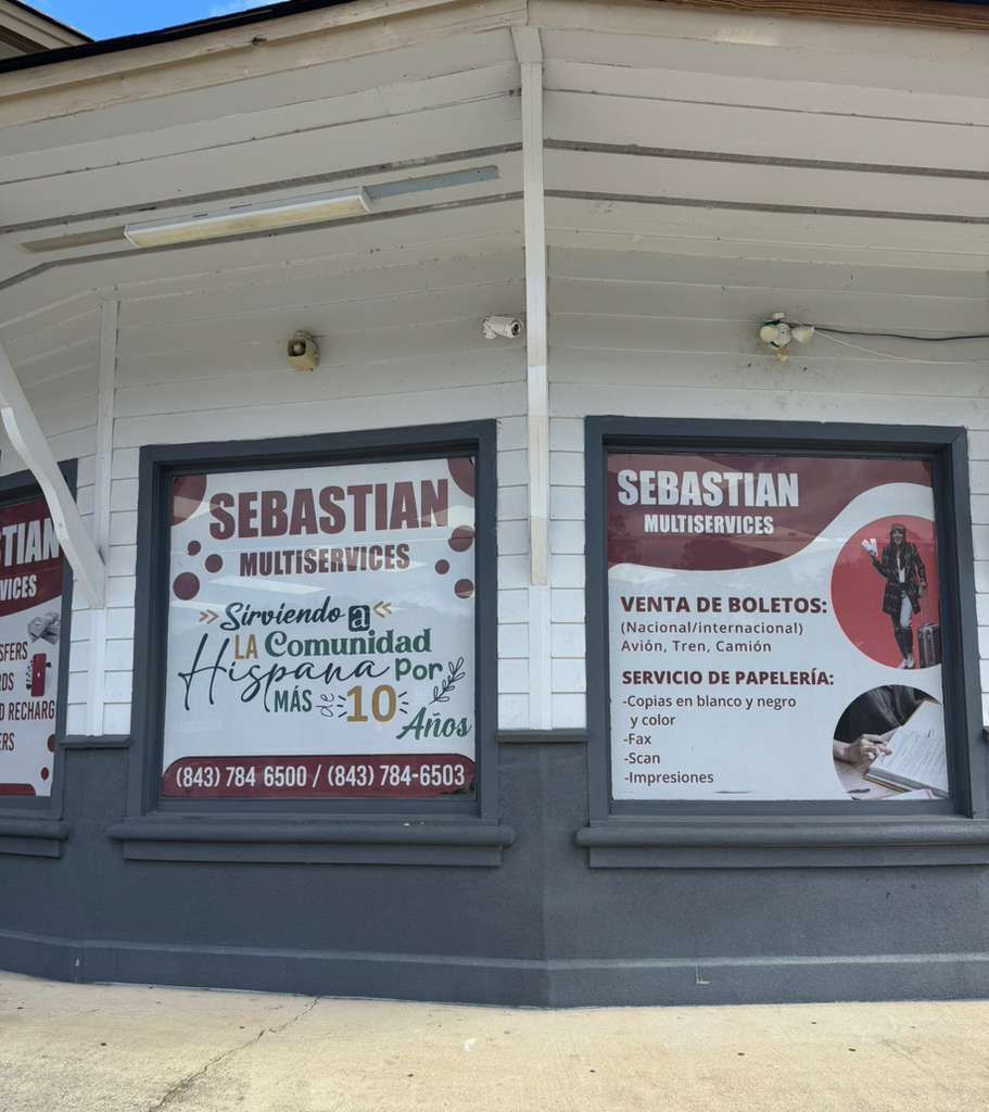 Tan commercial building with a blue sign that reads 