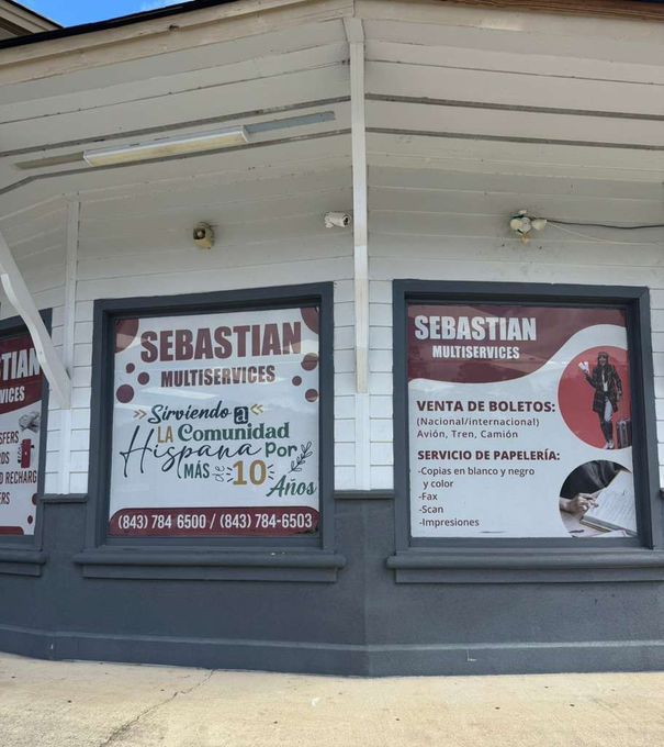 Tan commercial building with a blue sign that reads 